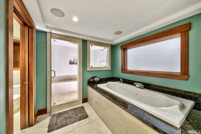 bathroom featuring tile patterned flooring, shower with separate bathtub, toilet, and plenty of natural light