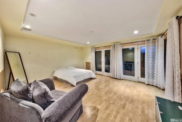 bedroom featuring access to outside, french doors, and light hardwood / wood-style floors