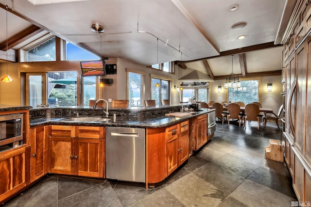 kitchen with decorative light fixtures, stainless steel appliances, dark tile patterned floors, sink, and lofted ceiling with beams