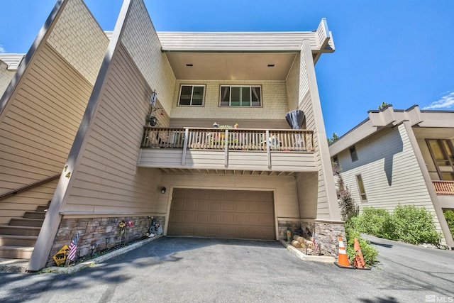 view of front of house featuring a balcony and a garage