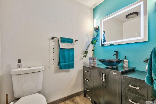 bathroom featuring hardwood / wood-style floors, vanity, and toilet