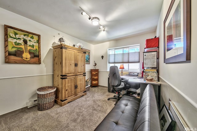 carpeted home office featuring track lighting