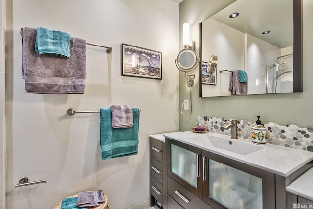 bathroom featuring vanity and a shower