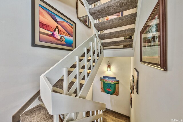 stairs with hardwood / wood-style floors