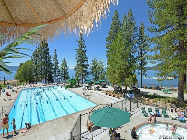 view of swimming pool featuring a patio area and a water slide