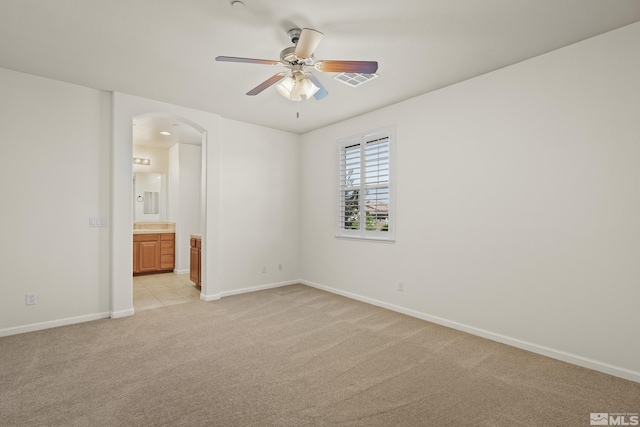 carpeted spare room with ceiling fan