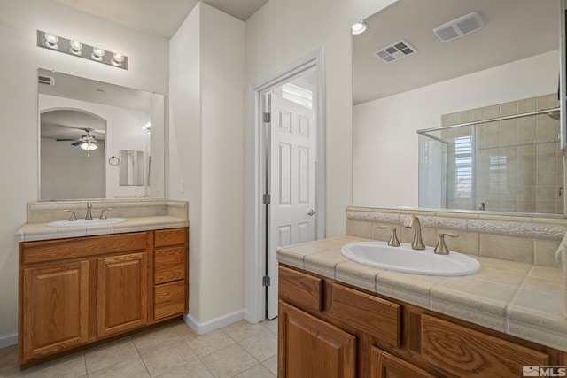 bathroom featuring vanity, a shower with shower door, ceiling fan, and tile patterned flooring