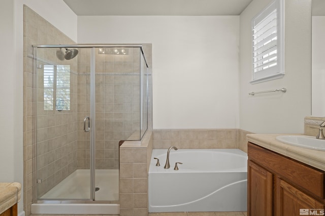 bathroom with tile patterned flooring, shower with separate bathtub, and vanity