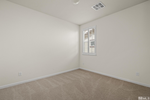 unfurnished room featuring carpet