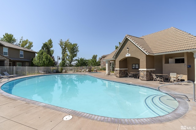 view of swimming pool featuring a patio area