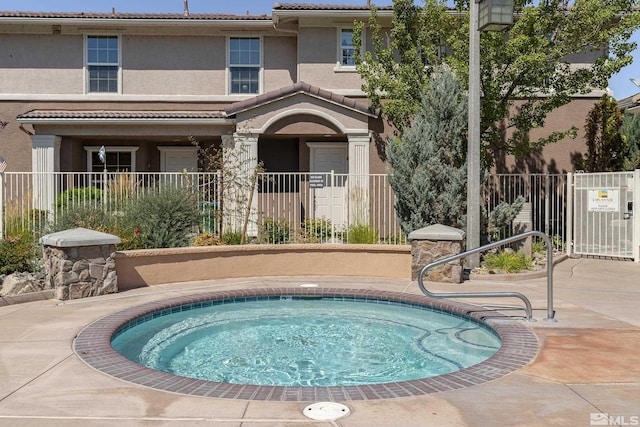 view of pool with a patio area and a community hot tub