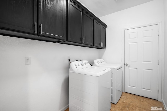 washroom featuring cabinets and washing machine and clothes dryer