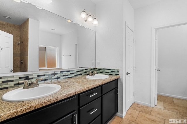 bathroom featuring tasteful backsplash, vanity, and a shower