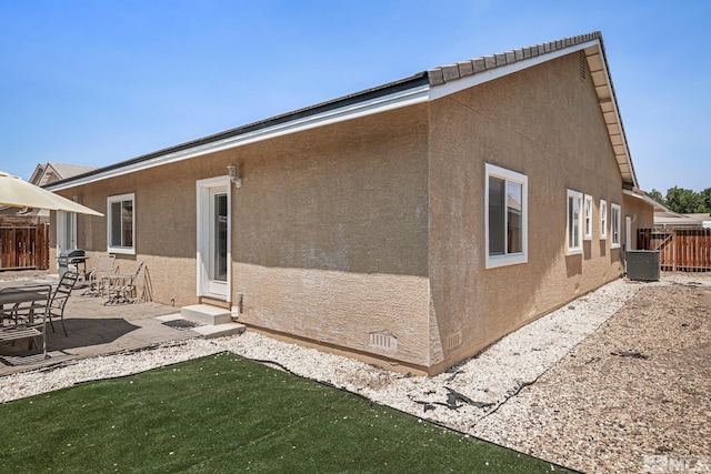 back of house with central AC and a patio