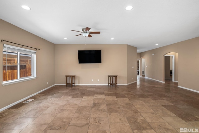 unfurnished living room featuring ceiling fan