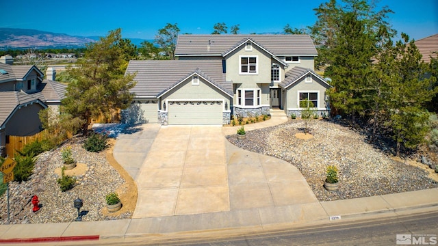 view of front facade with a mountain view and a garage