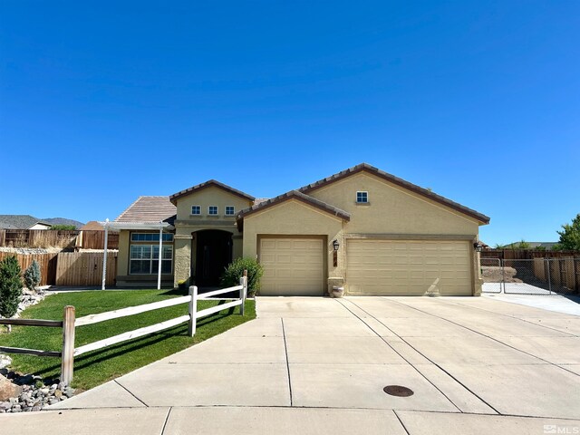 view of front of home featuring a garage and a front yard