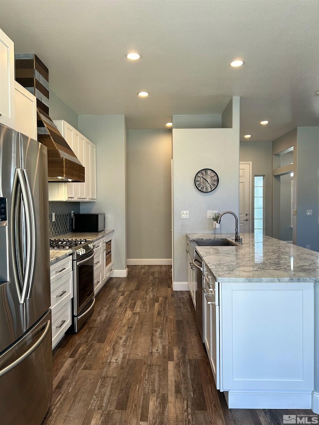 kitchen featuring white cabinets, light stone counters, stainless steel appliances, dark hardwood / wood-style floors, and sink