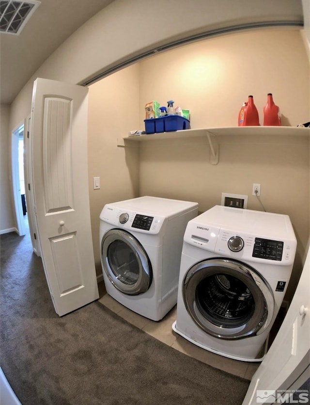 clothes washing area with independent washer and dryer and carpet flooring