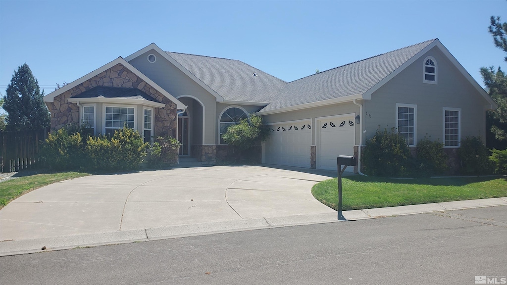 ranch-style house with a garage and a front yard