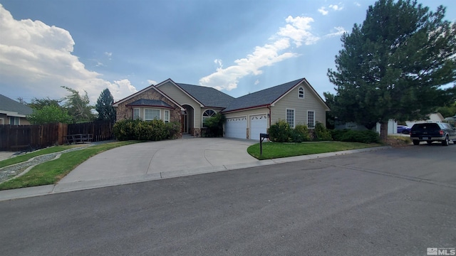 view of front of property with a garage and a front yard