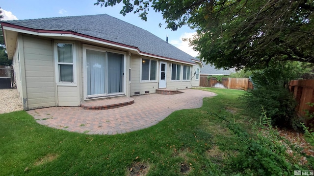 back of property featuring a patio area and a yard