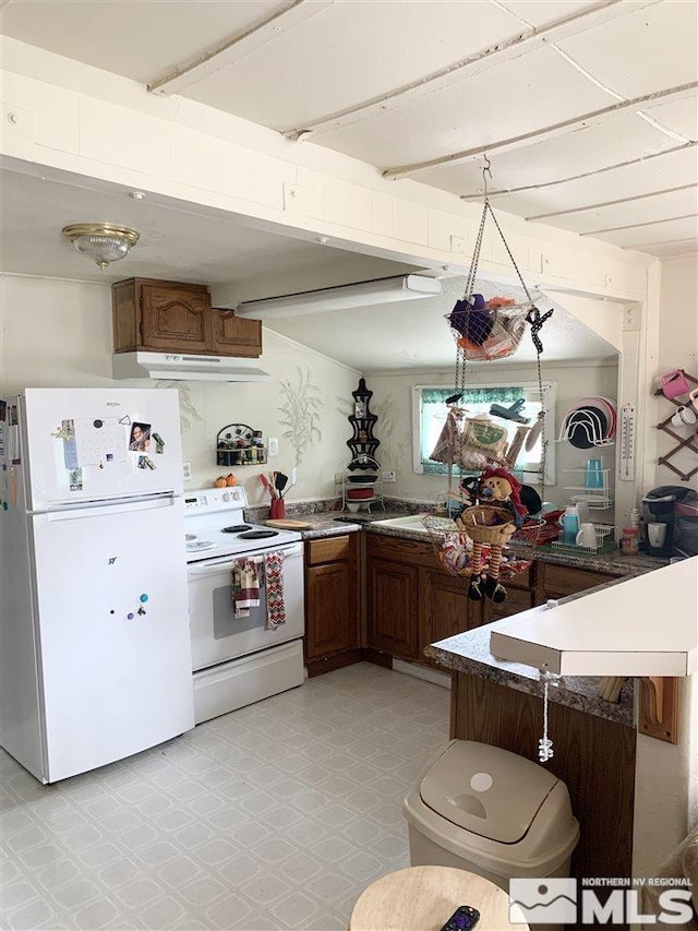 kitchen with light tile patterned flooring and white appliances