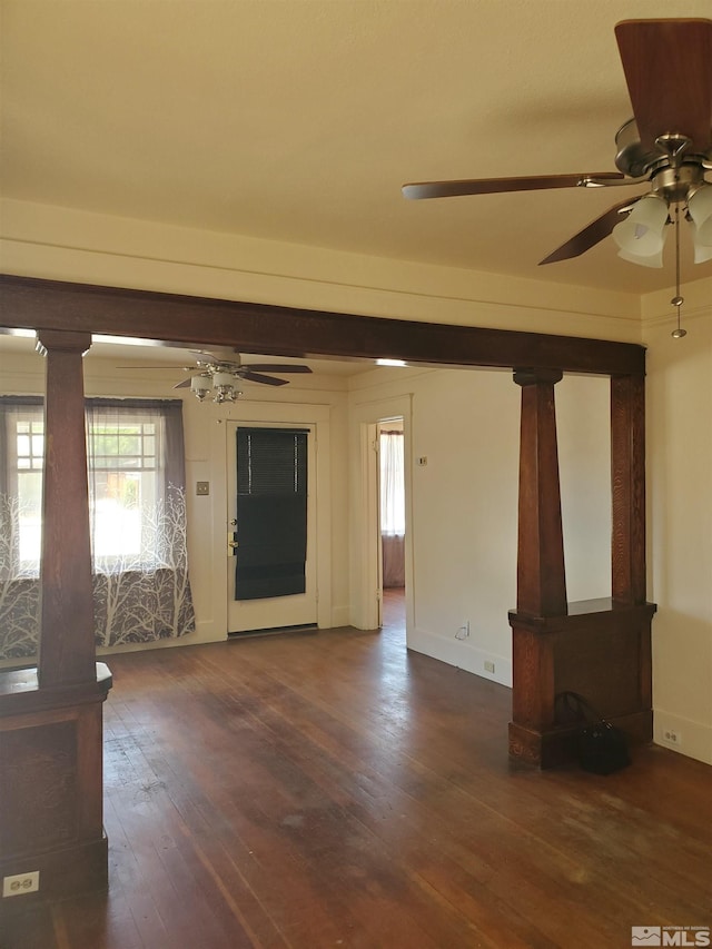 spare room with dark wood-type flooring and ceiling fan