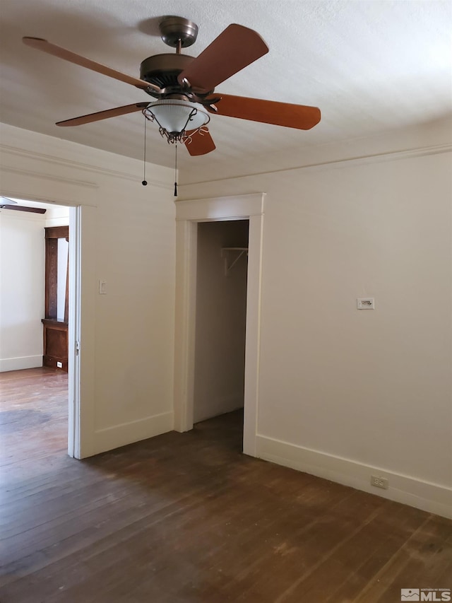 empty room with ceiling fan and hardwood / wood-style floors