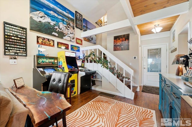 interior space featuring beamed ceiling, dark hardwood / wood-style floors, and wooden ceiling