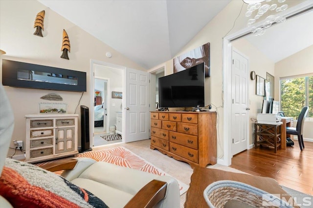 living room featuring light hardwood / wood-style flooring and vaulted ceiling