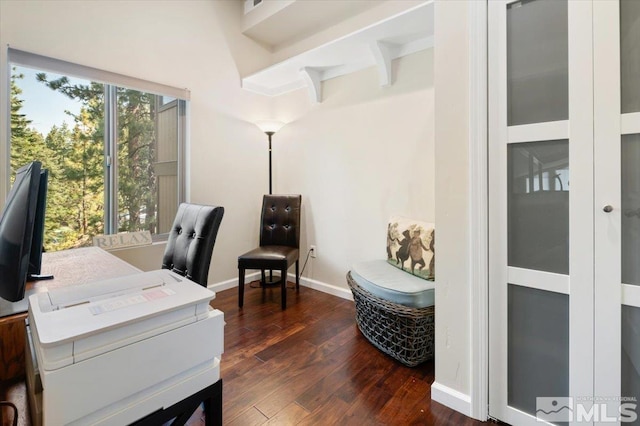 office area with dark hardwood / wood-style flooring and beamed ceiling