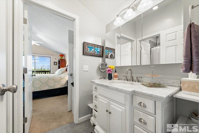 bathroom with vanity and vaulted ceiling