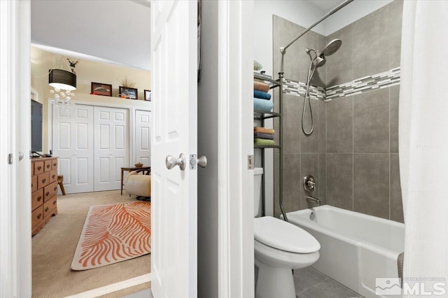 bathroom featuring shower / bath combo and toilet