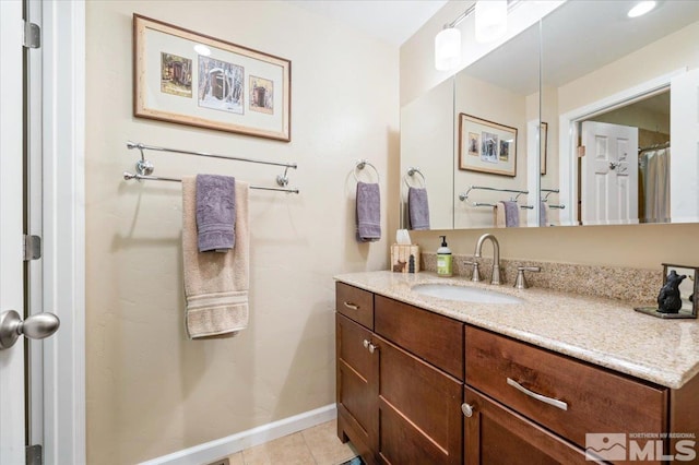 bathroom featuring tile patterned flooring and vanity