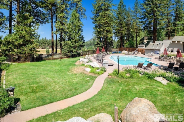 view of pool with a yard and a patio