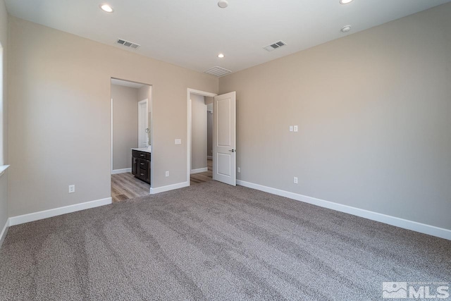 unfurnished bedroom with light carpet