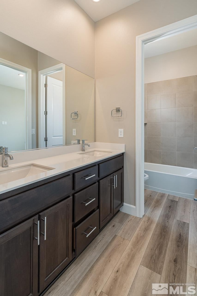 full bathroom featuring shower / bathtub combination, vanity, toilet, and hardwood / wood-style floors