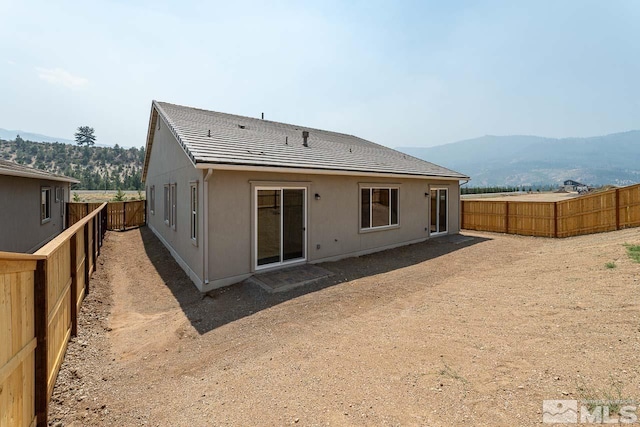 rear view of house featuring a mountain view