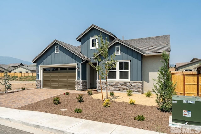 craftsman inspired home featuring a garage and a mountain view