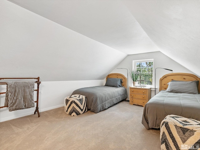 bedroom featuring vaulted ceiling and light carpet