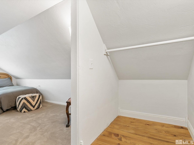 interior space with lofted ceiling and carpet flooring