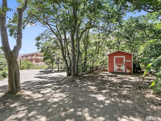 exterior space with a storage shed and a mountain view