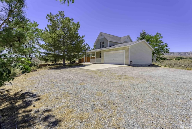 view of home's exterior featuring a garage and driveway