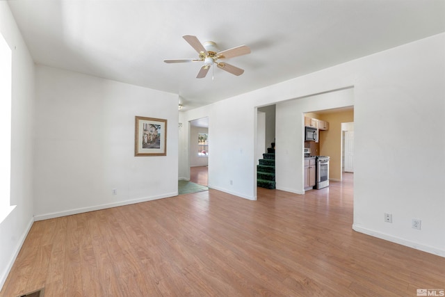 empty room featuring ceiling fan and light wood-type flooring