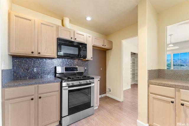 kitchen with light hardwood / wood-style flooring, stainless steel gas stove, backsplash, and light brown cabinets