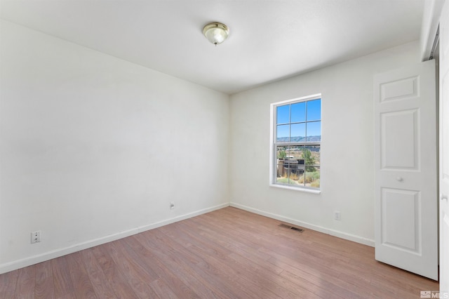 empty room with hardwood / wood-style flooring