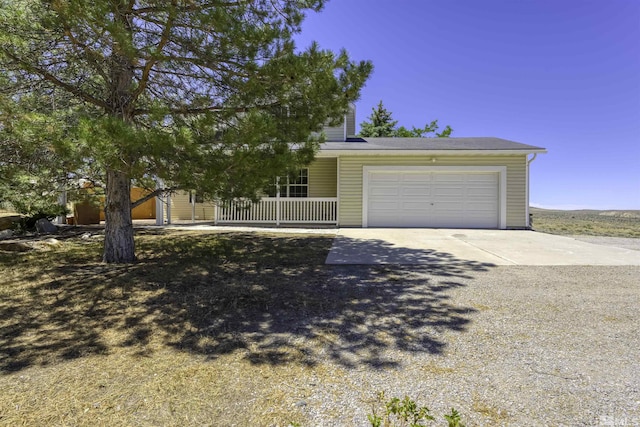 obstructed view of property with a porch, driveway, and a garage