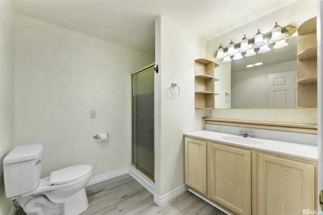 full bathroom with baseboards, toilet, wood finished floors, and a shower stall