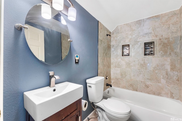 full bathroom with tiled shower / bath combo, toilet, and vanity